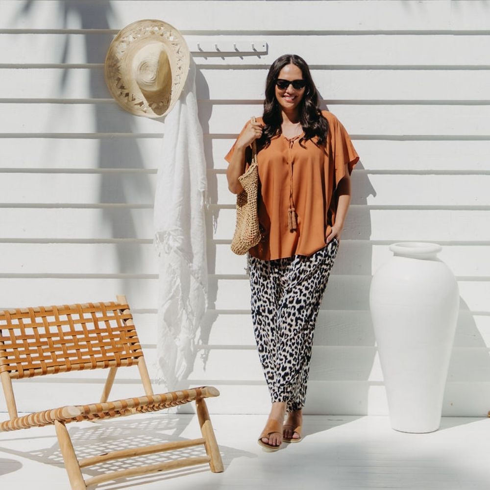 Woman wearing leopard print relaxed fit wide leg pants ready for day of market shopping