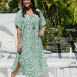 Model wearing long kaftan dress in emerald green and white Sorrento print – front view