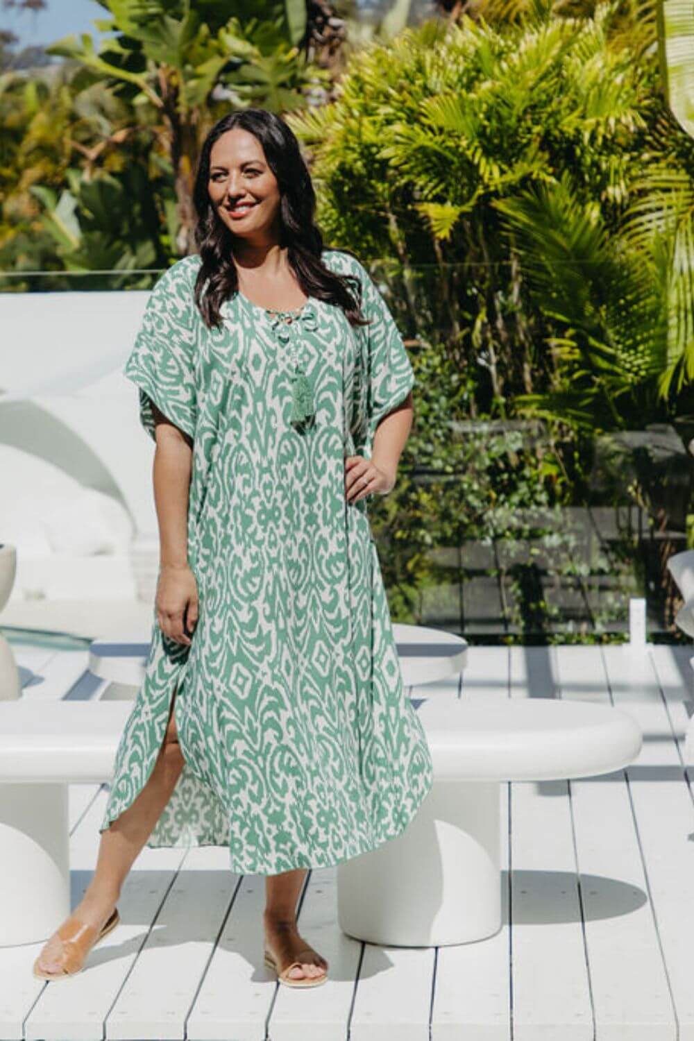 Model wearing long kaftan dress in emerald green and white Sorrento print – front view