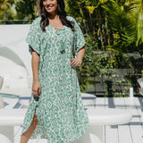 Model wearing long kaftan dress in emerald green and white Sorrento print – front view