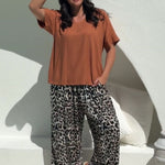 lady wearing casual summer outfit set of Palazzo Pants in Leopard Print paired with Mocha Mousse Blouse Top