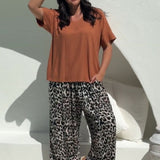 lady wearing casual summer outfit set of Palazzo Pants in Leopard Print paired with Mocha Mousse Blouse Top