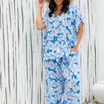 Woman wearing a blue floral outfit set at beach resort