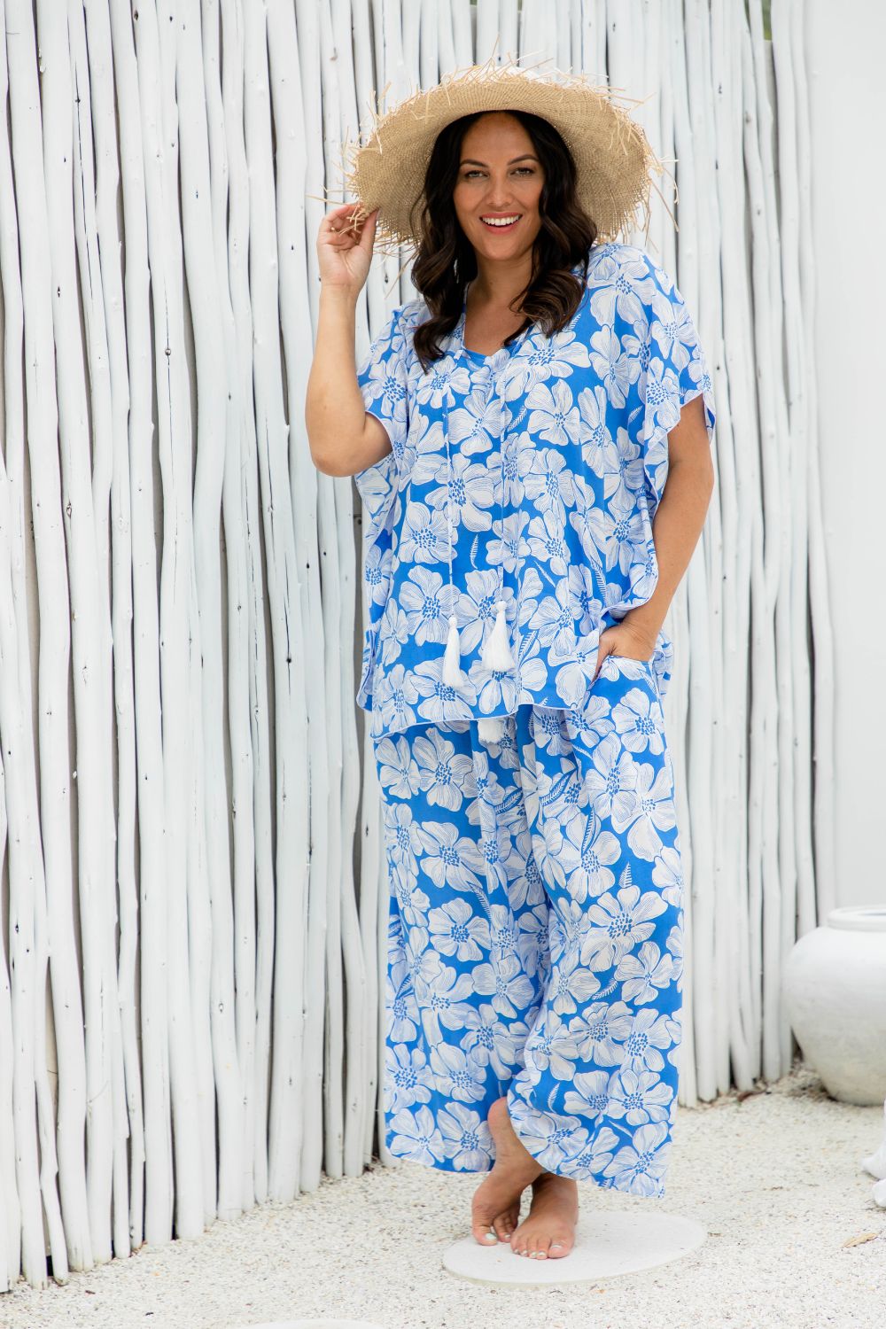 Woman wearing a blue floral outfit set at beach resort