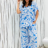 Woman wearing a blue floral outfit set at beach resort
