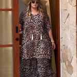 plus size woman walking out of Bali villa wearing outfit set of wide leg pants and short kaftan dress as co-ordinated look