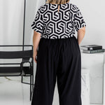 Back view of Amanda in black Palazzo Pants size L – wide-leg fit with relaxed resort style