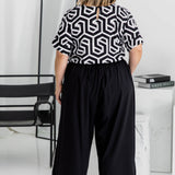 Back view of Amanda in black Palazzo Pants size L – wide-leg fit with relaxed resort style
