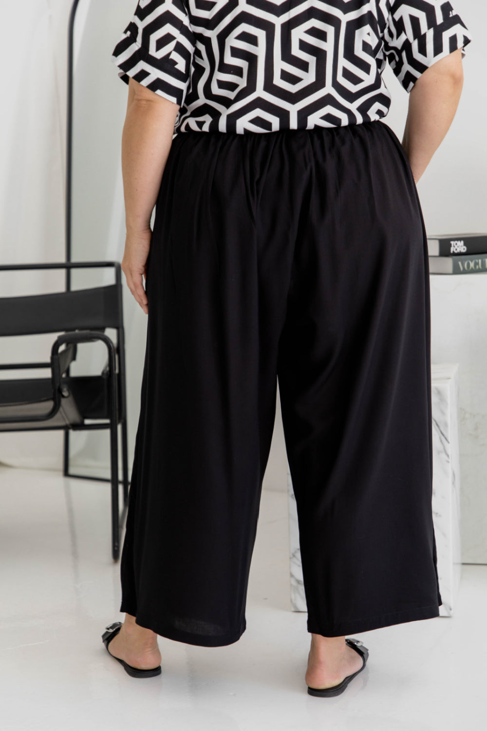 Half-length back view of black Palazzo Pants – relaxed wide-leg fit with soft drape