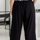 Half-length back view of black Palazzo Pants – relaxed wide-leg fit with soft drape