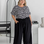 Amanda wearing black Palazzo Pants size L – full front view showing elastic waistband, drawstring, and pocket styling