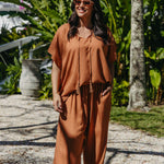 Front view of Alisha in Mocha Mousse Palazzo Pants size M styled with matching kaftan top tucked