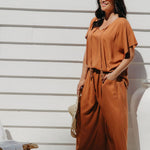 Partial side view of Alisha in Mocha Mousse Palazzo Pants size M showing functional side pocket detail