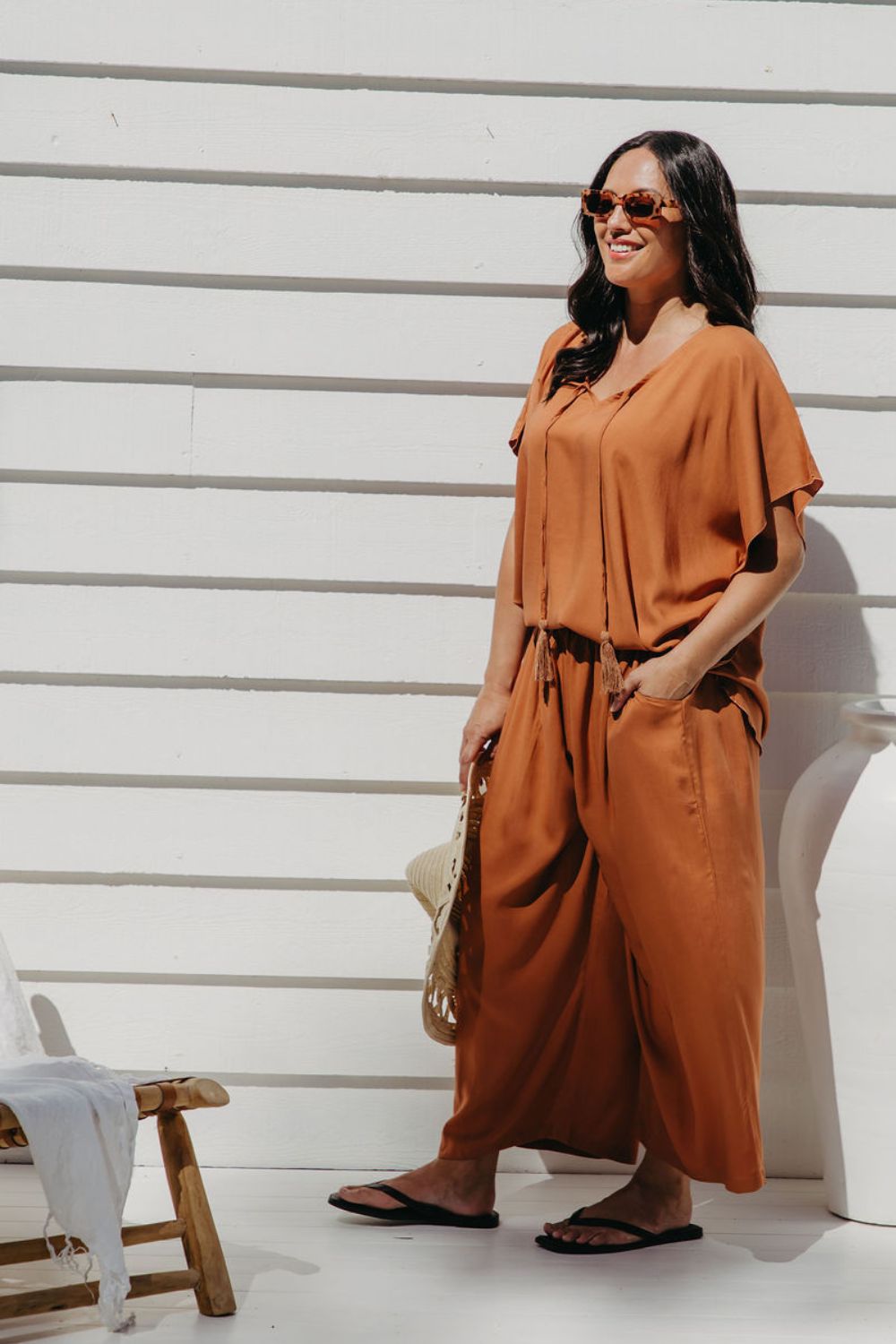 Partial side view of Alisha in Mocha Mousse Palazzo Pants size M showing functional side pocket detail