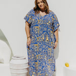 Woman wearing plus size maxi dress in Italian seaside resort for summer
