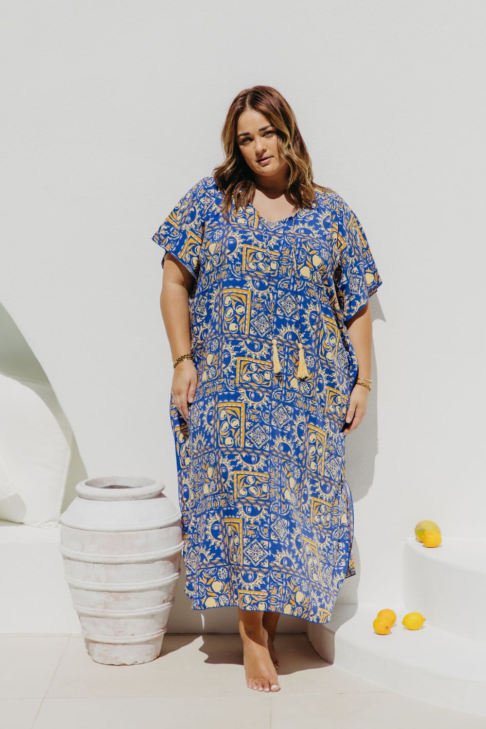 Woman wearing plus size maxi dress in Italian seaside resort for summer