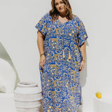 Woman wearing plus size maxi dress in Italian seaside resort for summer