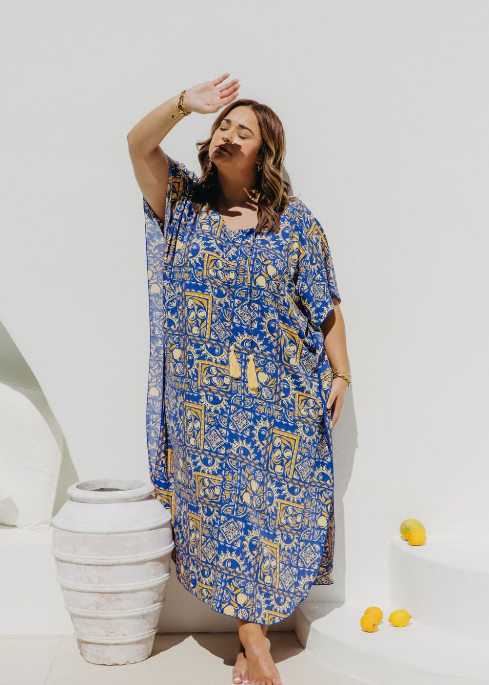 Woman wearing a Limoncello inspired Long Summer Dress enjoying dappled sunlight in Amalfi coast resort