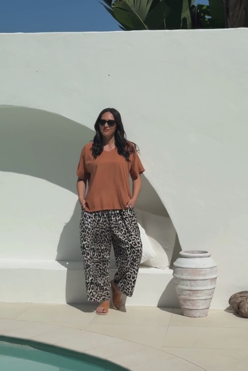 lady wearing a relaxed fit brown summer top and leopard print Palazzo pants 