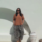 lady wearing a relaxed fit brown summer top and leopard print Palazzo pants 