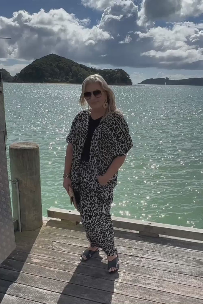See how our Leopard Trio Resort Set looks on a real traveller enjoying a cruise stop in the beautiful Bay of Islands, New Zealand. Designed for women who want to feel stylish and comfortable while exploring the world, this coordinated three-piece outfit is perfect for cruise shore excursions, sightseeing, waterfront lunches and relaxed holiday evenings. Featuring a flowing leopard print kimono, classic black blouse and matching palazzo pants, it's effortless resort wear that travels beautifully.