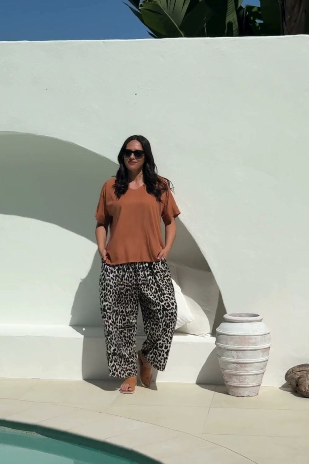 lady wearing a relaxed fit brown summer top and leopard print Palazzo pants 