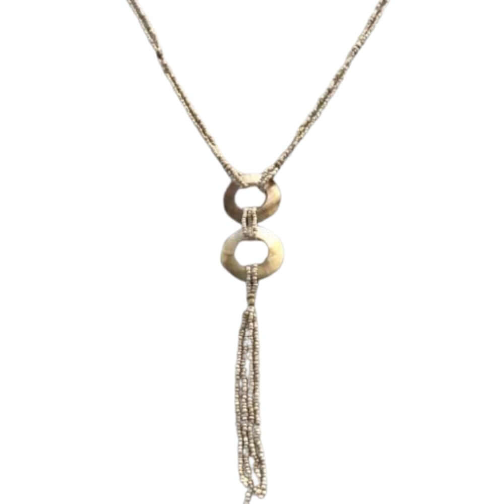A sea-shell necklace featuring a textured chain, two stacked circular ring pendants, and a long dangling beaded fringe, shown against a plain white background.