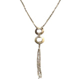 A sea-shell necklace featuring a textured chain, two stacked circular ring pendants, and a long dangling beaded fringe, shown against a plain white background.