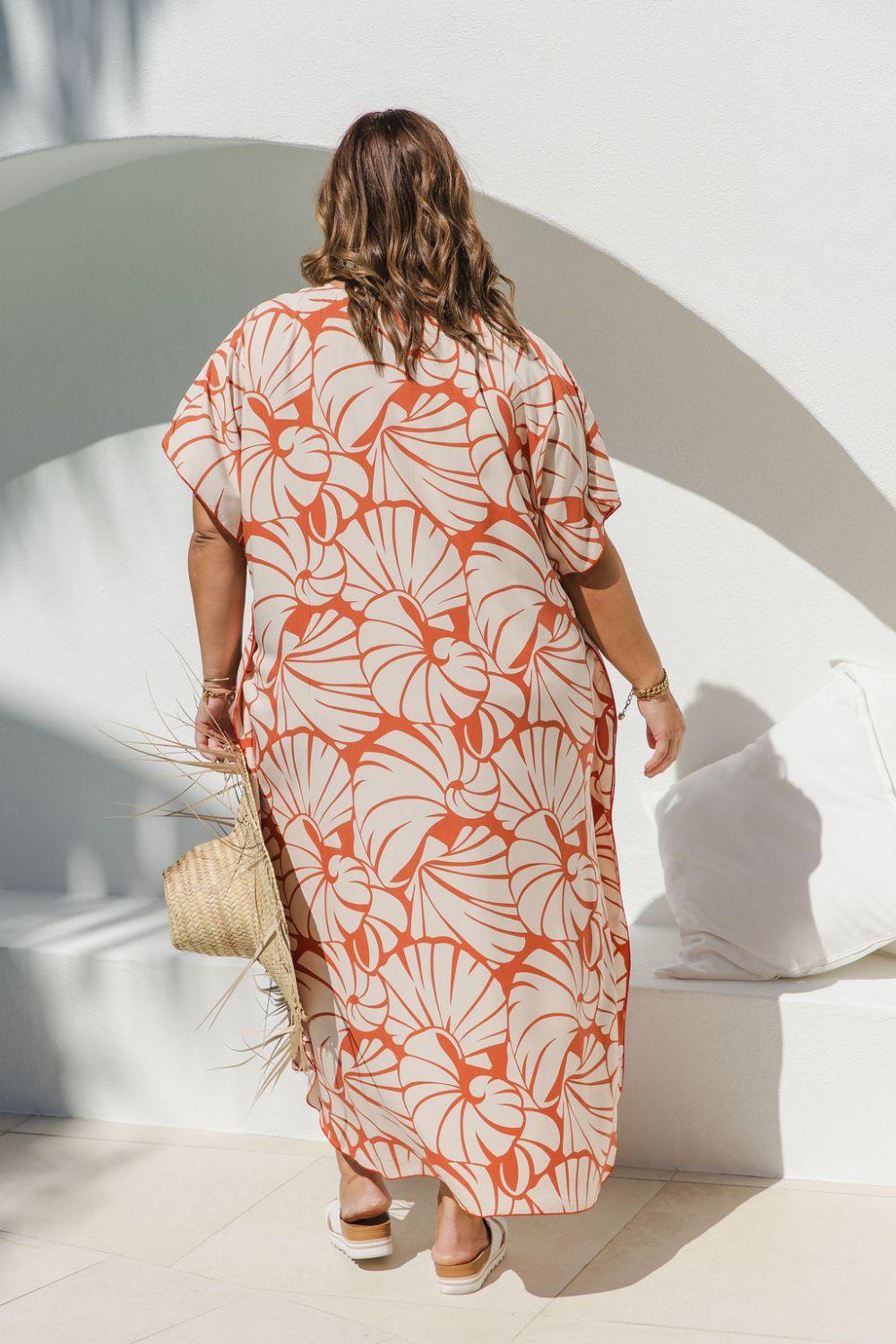 Back view of plus-size model wearing Shell Maxi Kaftan in Pomegranate, showing relaxed drape and bold shell print detail
