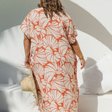 Back view of plus-size model wearing Shell Maxi Kaftan in Pomegranate, showing relaxed drape and bold shell print detail