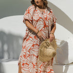 Plus-size model wearing Shell Maxi Kaftan in Pomegranate, showing flattering drape and bold shell print