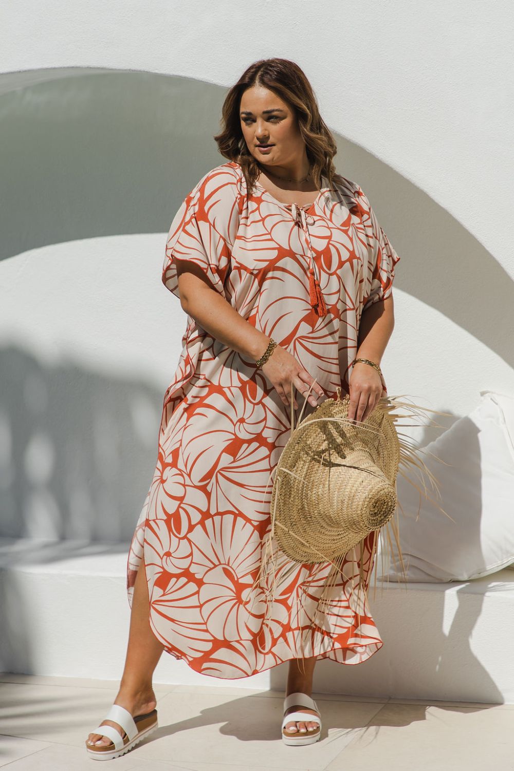 Plus-size model wearing Shell Maxi Kaftan in Pomegranate, showing flattering drape and bold shell print
