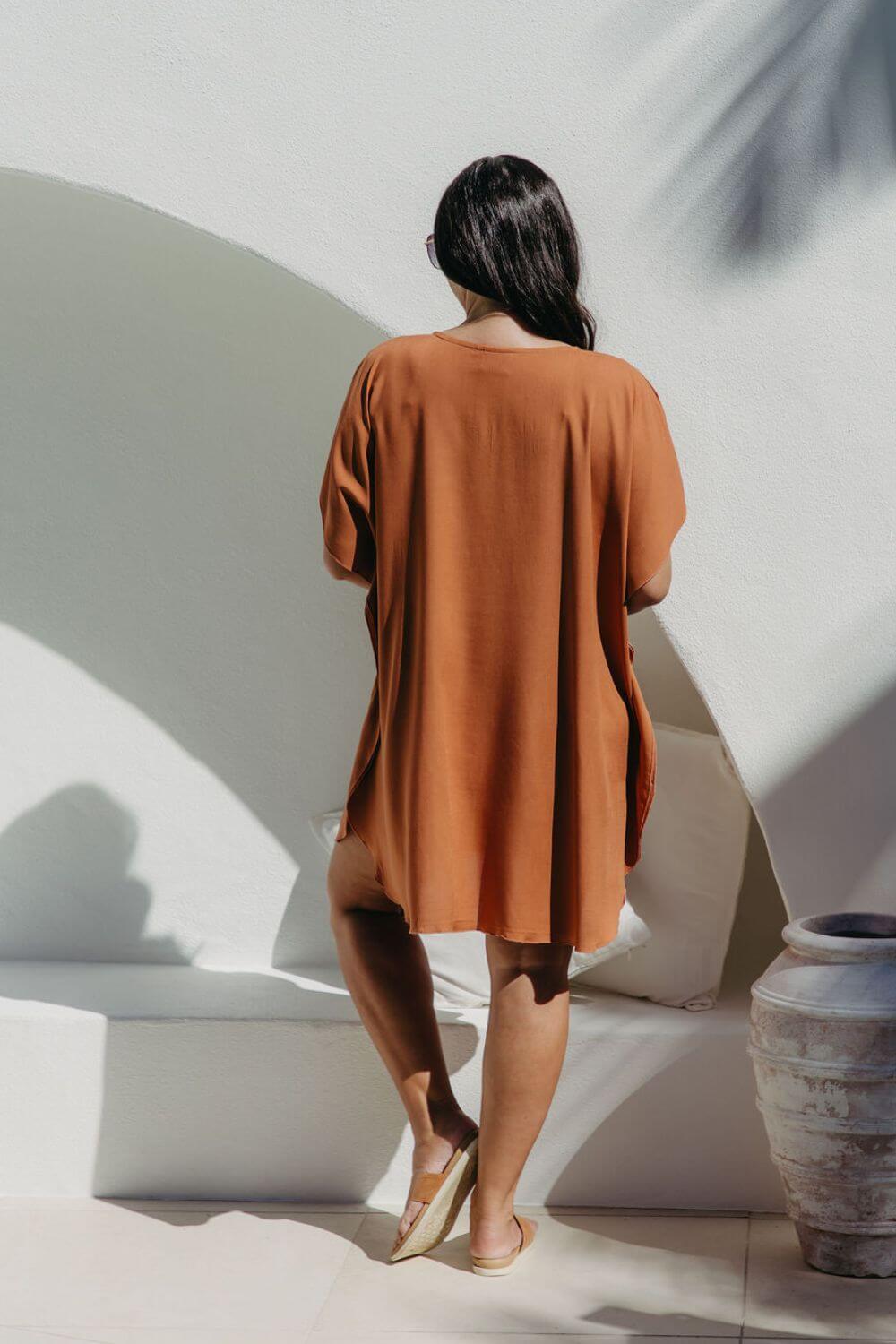 Back view of the Mocha Mousse short kaftan dress on a size S/M model, showing relaxed fit and just above-knee length