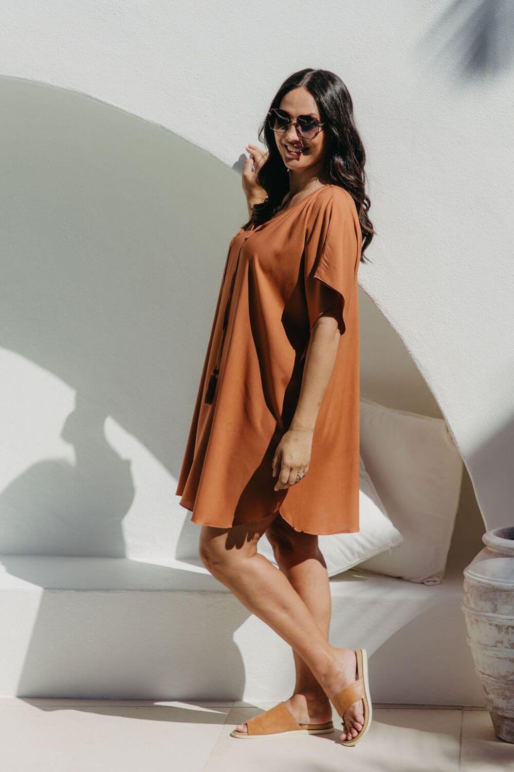 Side view of the Mocha Mousse short kaftan dress on a size S/M model, showing kimono sleeve drape and fluid silhouette
