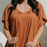 Close-up of the Mocha Mousse short kaftan dress showing the soft V-neckline and hand-made cotton tassels