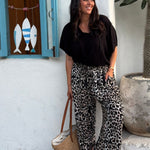 Model wearing the Vacay Vibes Outfit Set with Black Kaftan Top and Leopard Wide Leg Pants