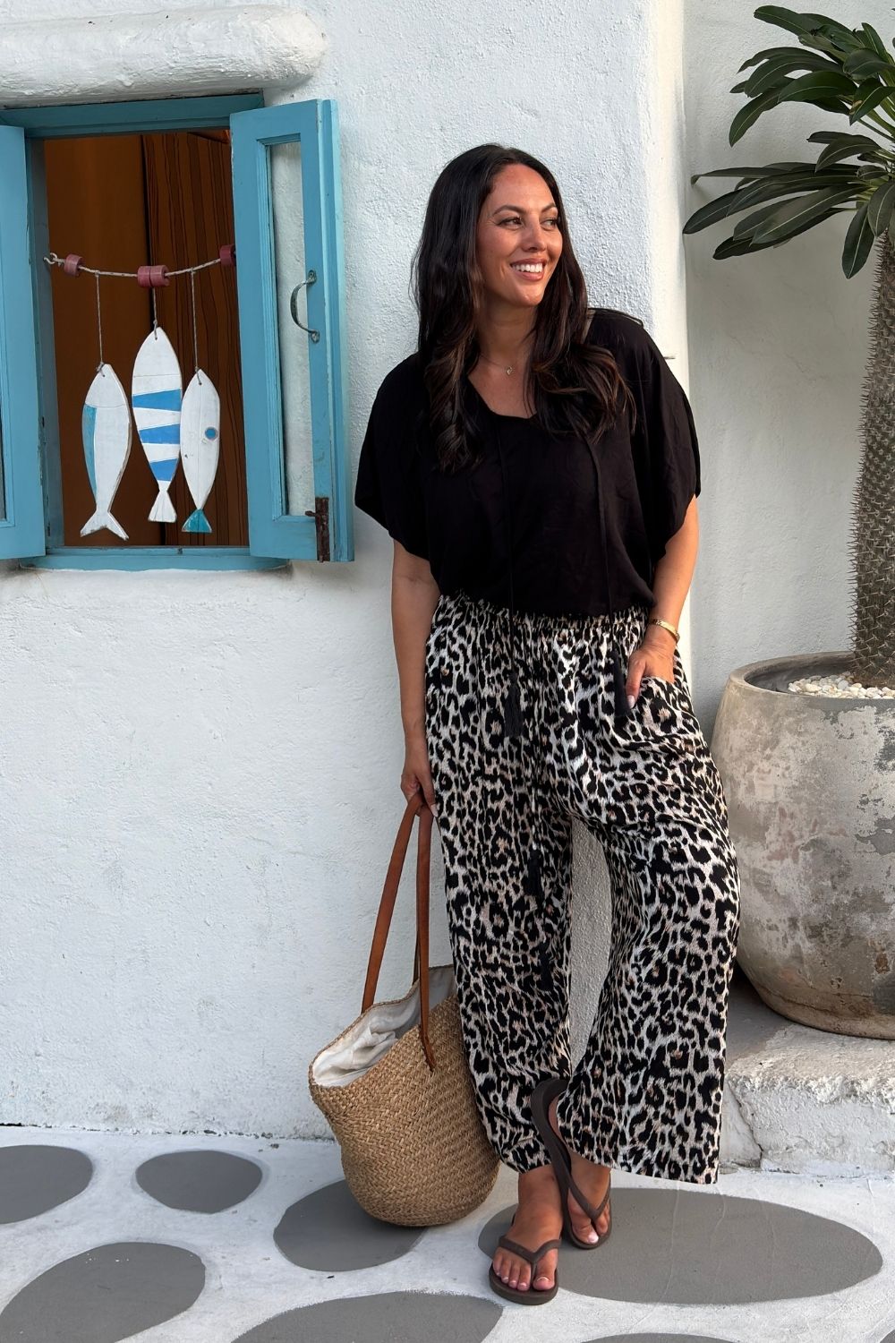 Model wearing the Vacay Vibes Outfit Set with Black Kaftan Top and Leopard Wide Leg Pants