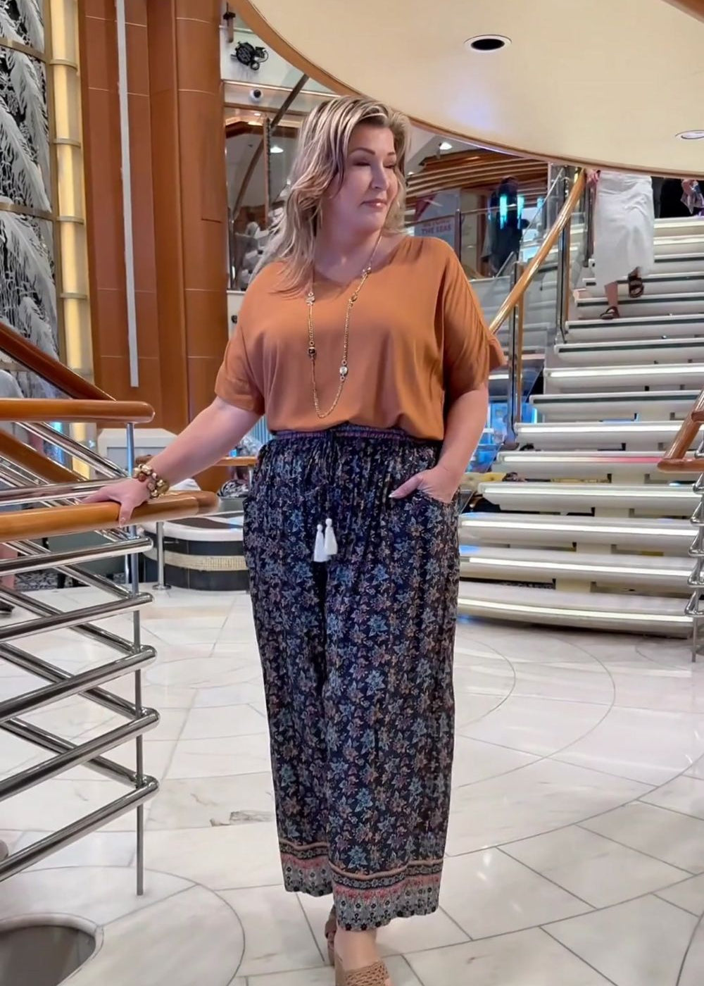 Regina-Barnes-wearing-floral-relaxed-fit-pants-paired-with-mocha-top-on-Queensland-cruise