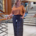 Regina-Barnes-wearing-floral-relaxed-fit-pants-paired-with-mocha-top-on-Queensland-cruise