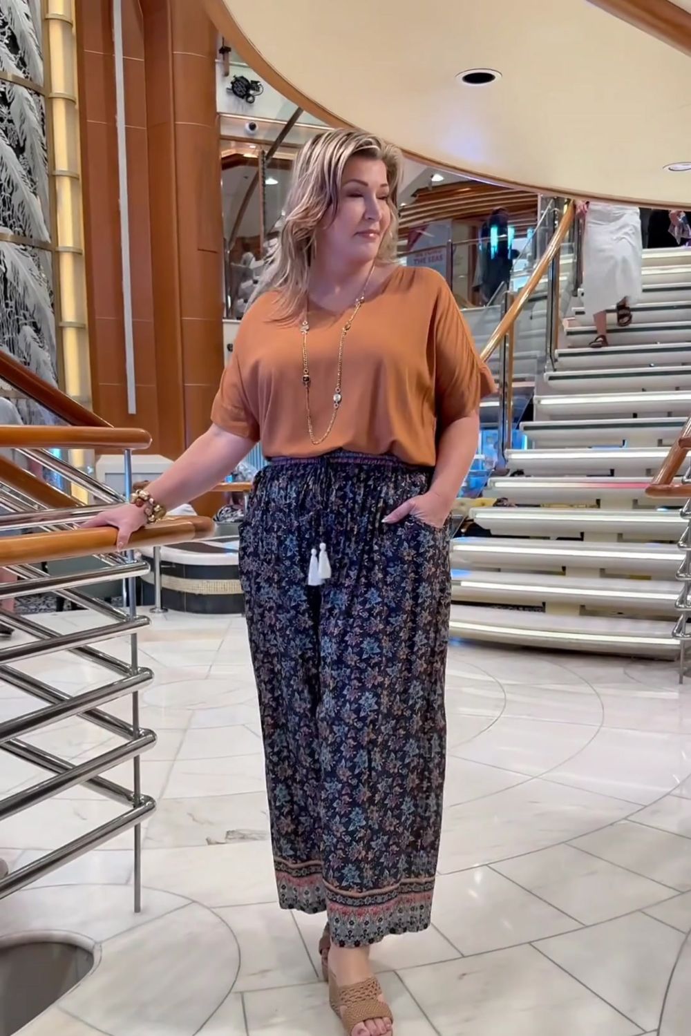 Regina-Barnes-wearing-floral-relaxed-fit-pants-paired-with-mocha-top-on-Queensland-cruise