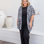 Front view of black and grey zebra print kimono cape with relaxed open drape