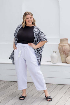 Zebra print kimono cape styled with white cotton pants and black t-shirt for relaxed resort layering