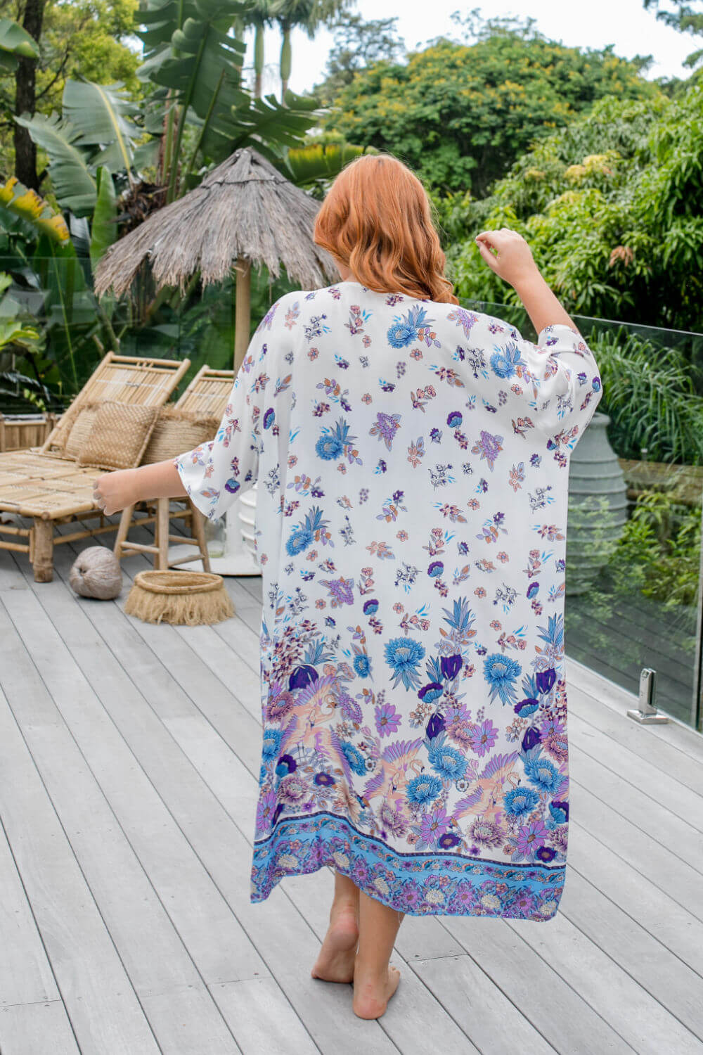 Back view of blue floral maxi kimono jacket showing full-length drape