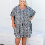 Front view of plus size model in 2XL kaftan showing full length fit and draped cotton tassels.