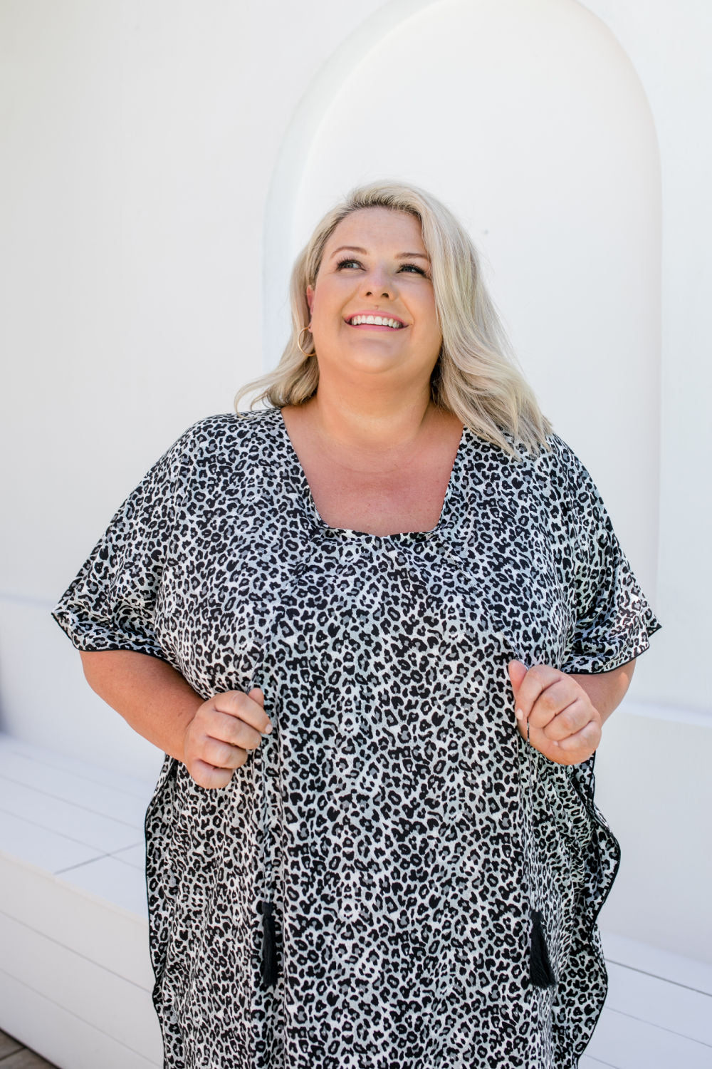 Close-up of rayon leopard print fabric in black, grey and white showing texture and pattern details