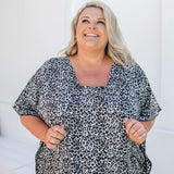 Close-up of rayon leopard print fabric in black, grey and white showing texture and pattern details