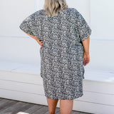 Back view of plus size model in 2XL leopard print kaftan showing relaxed fit and drape.