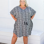 Plus size model wearing size 2XL leopard print kaftan with hands on hips, showing kimono sleeve details.