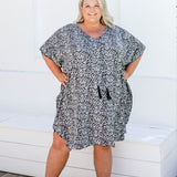 Plus size model wearing size 2XL leopard print kaftan with hands on hips, showing kimono sleeve details.